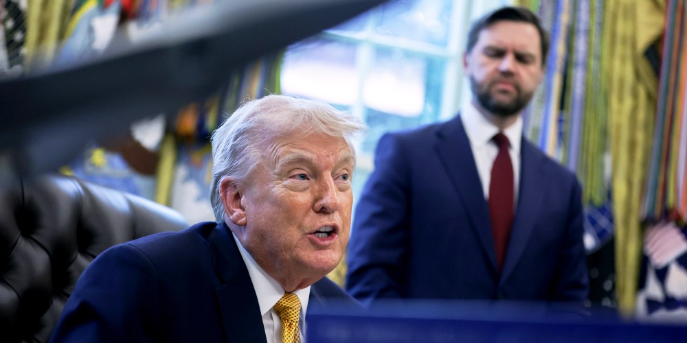 President Donald Trump speaks to the media as Vice President JD Vance listens in the Oval Office of the White House.