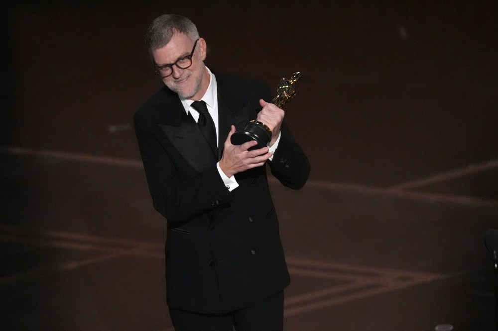 Paul Thomas Anderson accepts an Oscar on stage